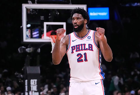 Philadelphia 76ers center Joel Embiid (21) pumps his fists after making a basket against the Boston Celtics during the second half of Game 5 of a first-round NBA playoffs basketball series, in Boston. 