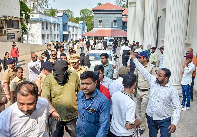 Police escort accused to a court in connection with a case related to the TCS unit, in Nashik, April 24, 2026. - PTI