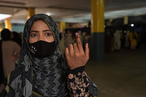 A woman shows her ink-marked finger after casting a vote in the second and final phase of the West Bengal Assembly elections, at a polling station in Kolkata.