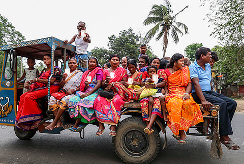 Voters arrive to cast votes at a polling booth during the West Bengal Assembly elections, in Purba Bardhaman district.