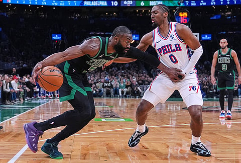 Boston Celtics guard Jaylen Brown, left, drives to the basket against Philadelphia 76ers guard Tyrese Maxey (0) during the first half of Game 5 of a first-round NBA playoffs basketball series, in Boston.
