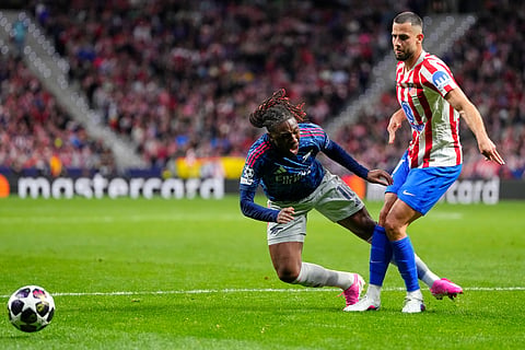 Atletico Madrid's David Hancko, right, challenges Arsenal's Eberechi Eze for which a penalty was awarded and then rescinded after a VAR review during a Champions League semifinal, first leg, soccer match between Atletico Madrid and Arsenal in Madrid.