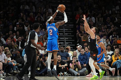Oklahoma City Thunder guard Shai Gilgeous-Alexander (2) shoot a 3-pointer against Phoenix Suns guard Collin Gillespie (12) during the first half of Game 4 in a first-round NBA playoffs basketball series, in Phoenix.