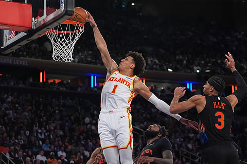 Atlanta Hawks' Jalen Johnson (1) dunks the ball in front of New York Knicks' Josh Hart (3) during the second half in Game 5 of a first-round NBA playoffs basketball series, in New York. 