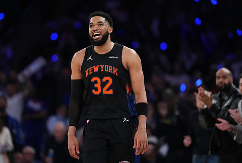 New York Knicks' Karl-Anthony Towns (32) smiles during the first half in Game 5 of a first-round NBA playoffs basketball series against the Atlanta Hawks, in New York.