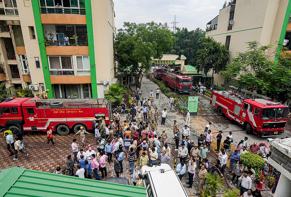 | Photo: PTI/Kamal Kishore : Fire brigade vehicles at the site after a fire broke out in Green Avenue Society, Indirapuram, Ghaziabad.