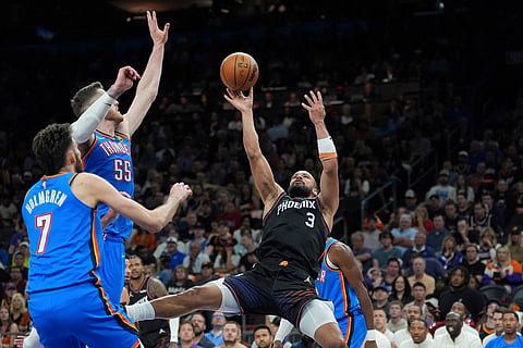 Phoenix Suns forward Dillon Brooks (3) tries to shoot over Oklahoma City Thunder centers Isaiah Hartenstein (55) and Chet Holmgren (7) during the first half of Game 4 in a first-round NBA playoffs basketball series in Phoenix.