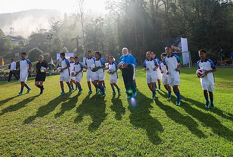 Prime Minister Narendra Modi plays football with youngsters during his visit to Sikkim, in Gangtok.
