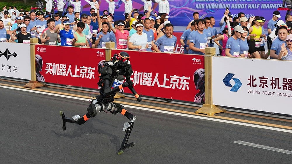A robot starts off for the Beijing E-Town Half Marathon and Humanoid Half Marathon on the outskirts of Beijing. - | Photo: AP/Ng Han Guan