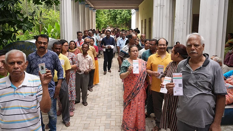 People wait in a queue to cast their votes during the second phase of the West Bengal Assembly elections, in Kolkata, Wednesday, April 29, 2026. - Sandipan Chatterjee