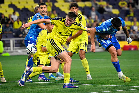 Nashville SC 2026 defender Reed Baker-Whiting (27) tries to stop UANL Tigres midfielder Rômulo Zanre, right, during the second half of an CONCACAF Champions Cup first leg semifinal soccer match in Nashville, Tennessee.