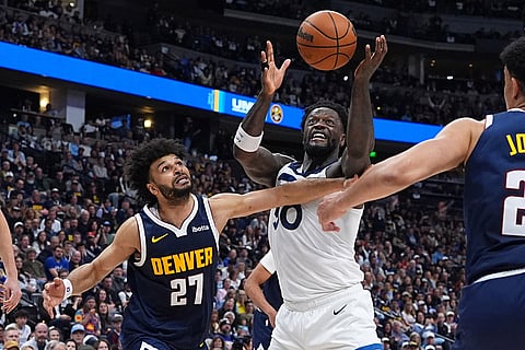 Minnesota Timberwolves forward Julius Randle, right, and Denver Nuggets guard Jamal Murray pursue a loose ball in the second half in Game 5 of a first-round NBA playoffs basketball series Monday, April 27, 2026, in Denver. ()