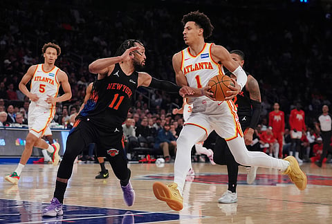 New York Knicks' Jalen Brunson (11) defends Atlanta Hawks' Jalen Johnson (1) during the second half in Game 5 of a first-round NBA playoffs basketball series, in New York. 