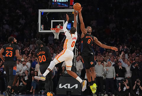 New York Knicks' Og Anunoby (8) blocks a shot by Atlanta Hawks' Jonathan Kuminga (0) during the first half in Game 5 of a first-round NBA playoffs basketball series, Tuesday, April 28, 2026, in New York. 