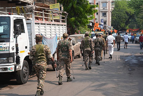 Security personnel conduct a route march amid the West Bengal Assembly elections 2026