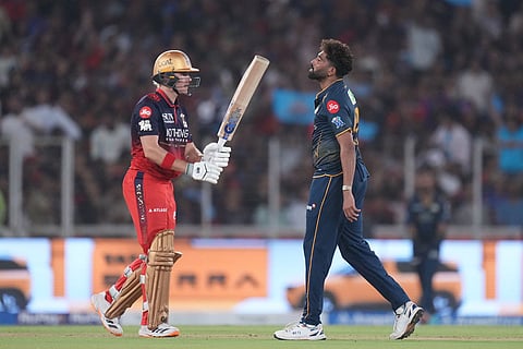 Gujarat Titans' Mohammed Siraj celebrates the wicket of Royal Challengers Bengaluru's Jacob Bethell during the Indian Premier League cricket match between Gujarat Titans and Royal Challengers Bengaluru in Ahmedabad, India.