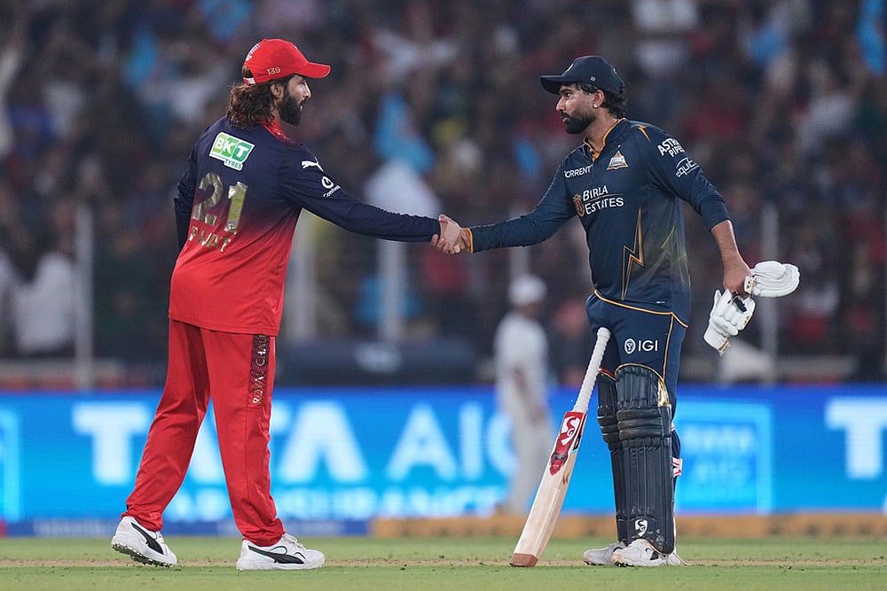 | Photo: AP/Ajit Solanki : Gujarat Titans' Rahul Tewatia shakes hands with Royal Challengers Bengaluru's captain Rajat Patidar after wining the Indian Premier League cricket match between Gujarat Titans and Royal Challengers Bengaluru in Ahmedabad, India.