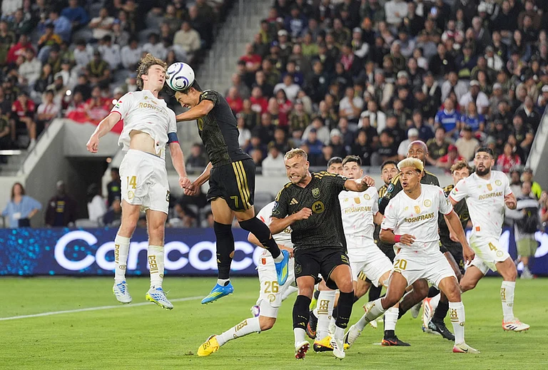 LAFC forward Son Heung-Min (7) and Toluca midfielder Marcel Ruiz (14) jump for a header during the second half of the first leg of a CONCACAF Champions Cup semifinal soccer match in Los Angeles. - | Photo: AP/Jae C. Hong
