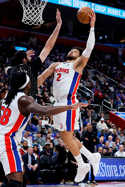 Detroit Pistons guard Cade Cunningham (2) goes to the basket against Orlando Magic center Goga Bitadze, left, during the first half in Game 5 of a first-round NBA basketball playoffs series in Detroit.