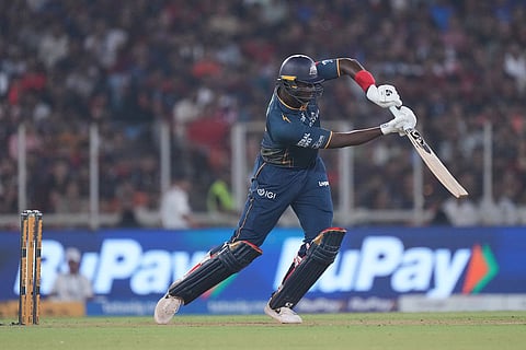 Gujarat Titans' Jason Holder plays a shot during the Indian Premier League cricket match between Gujarat Titans and Royal Challengers Bengaluru in Ahmedabad, India.