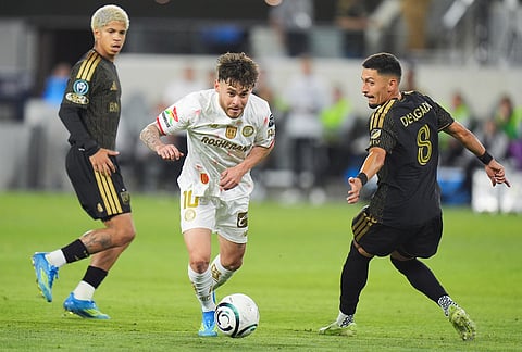 Toluca midfielder Jesus Angulo (10) movs the ball past LAFC midfielder Mark Delgado (8) during the second half of the first leg of a CONCACAF Champions Cup semifinal soccer match in Los Angeles.