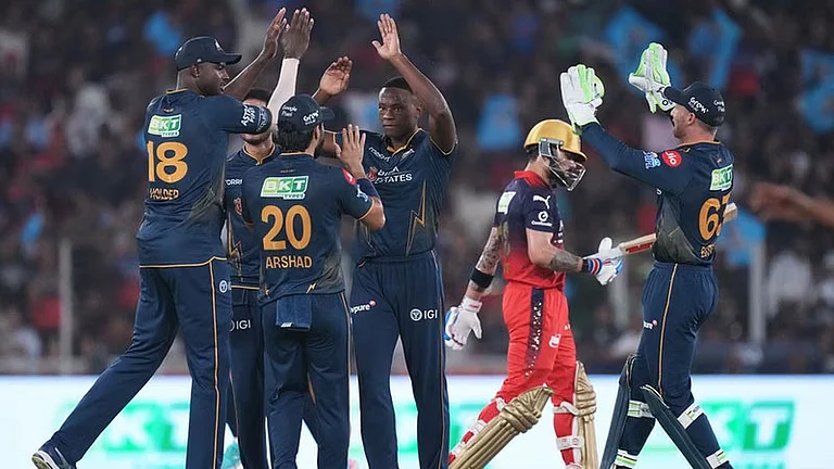 Kagiso Rabada celebrates with teammates the wicket of Virat Kohli during the Indian Premier League match between Gujarat Titans and Royal Challengers Bengaluru in Ahmedabad. - AP