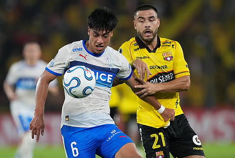 Sebastian Arancibia of Chile's Universidad Catolica controls the ball challenged by Hector Villalba of Ecuador's Barcelona during a Copa Libertadores Group D soccer match in Guayaquil, Ecuador.
