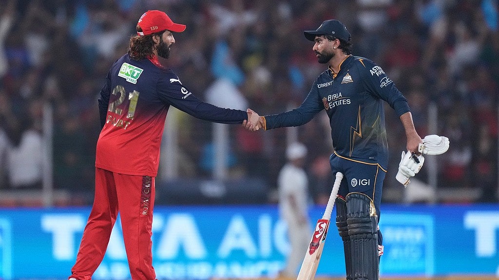 Rahul Tewatia shakes hands with Rajat Patidar after Gujarat Titans win the Indian Premier League match against Royal Challengers Bengaluru in Ahmedabad. - Photo: AP