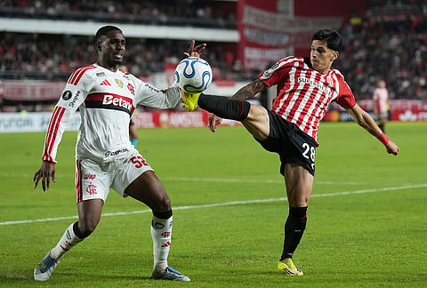 Evertton Araujo of Brazil's Flamengo, left, and Brian Aguirre of Argentina's Estudiantes de La Plata battle for the ball during a Copa Libertadores Group A soccer match in La Plata, Argentina.