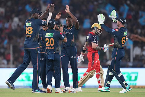 Gujarat Titans' Kagiso Rabada celebrate with teammates the wicket of Royal Challengers Bengaluru's Virat Kohli during the Indian Premier League cricket match between Gujarat Titans and Royal Challengers Bengaluru in Ahmedabad, India.