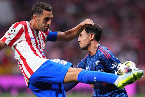 Arsenal's Martin Zubimendi, right, tries to block a shot by Atletico Madrid's Koke during a Champions League semifinal, first leg, soccer match between Atletico Madrid and Arsenal in Madrid, Spain.
