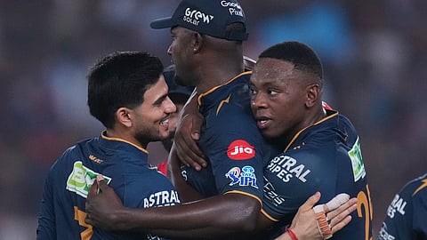 Shubman Gill, left, looks at teammate Kagiso Rabada as they celebrate the wicket of Rajat Patidar during the Indian Premier League match between Gujarat Titans and Royal Challengers Bengaluru in Ahmedabad.