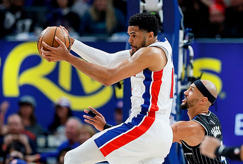 Detroit Pistons forward Tobias Harris, left, grabs a defensive rebound against Orlando Magic guard Jalen Suggs, right, during the first half in Game 5 of a first-round NBA basketball playoffs series in Detroit. 