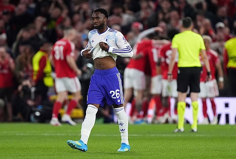 Aston Villa's Lamare Bogarde stands dejected as Nottingham Forest players celebrate a goal during the Europa League semifinal first leg soccer match between Nottingham Forest and Aston Villa in Nottingham, England.