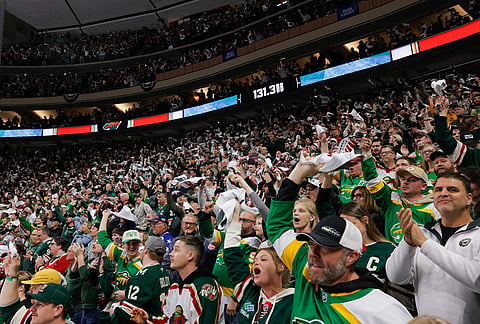 Minnesota Wild fans cheer during the third period of Game 6 in the first round of the NHL hockey Stanley Cup playoff series against the Dallas Stars, in St. Paul, Minnesota.