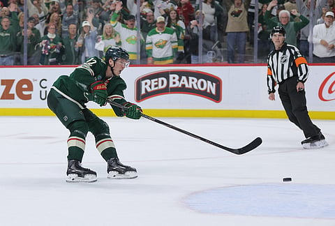 Minnesota Wild left wing Matt Boldy (12) shoots and scores during the third period of Game 6 in the first round of the NHL hockey Stanley Cup playoff series against the Dallas Stars, in St. Paul, Minnesota.