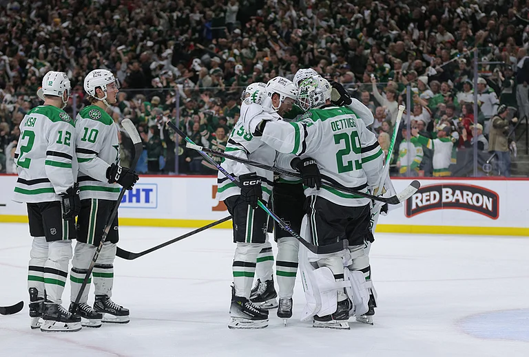 Dallas Stars goaltender Jake Oettinger (29) is greeted by teammates after they lost Game 6 in the first round of the NHL hockey Stanley Cup playoff series against the Minnesota Wild, in St. Paul, Minnesota. - | Photo: AP/Bailey Hillesheim