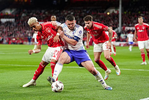 Aston Villa's John McGinn and Nottingham Forest's Omari Hutchinson, left, battle for the ball during the Europa League semifinal first leg soccer match between Nottingham Forest and Aston Villa in Nottingham, England.
