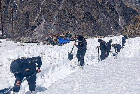 Army personnel clear snow from the premises of Gurudwara Hemkunt Sahib ahead of its portal opening ceremony, scheduled to be on May 23rd, in Chamoli district, Uttarakhand.