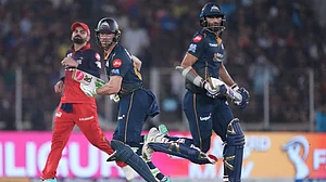 | Photo: AP/Ajit Solanki : Gujarat Titans' Washington Sundar, right, and Jos Buttler run between the wickets during the Indian Premier League cricket match between Gujarat Titans and Royal Challengers Bengaluru in Ahmedabad, India.
