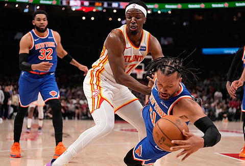 New York Knicks guard Jalen Brunson (11) and Atlanta Hawks forward Onyeka Okongwu (17) fight for the ball in the first half during Game 6 in a first-round NBA basketball playoffs series in Atlanta. 