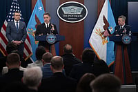 60 Days Of West Asia Conflict: A War Without Victory U.S. Secretary of Defense Pete Hegseth, left, U.S. Central Command Commander Adm. Brad Cooper, center, and Chairman of the Joint Chiefs Gen. Dan Caine, right, listen to a question, during a press briefing to discuss the ceasefire and situation with Iran in Operation Epic Fury at the Pentagon
