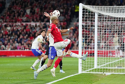 Aston Villa's Lucas Digne, covered, handles the ball in the penalty area resulting in a penalty to Nottingham Forest during the Europa League semifinal first leg soccer match between Nottingham Forest and Aston Villa in Nottingham, England.