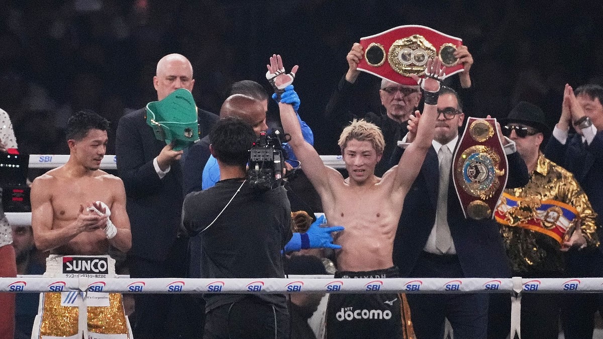 Naoya Inoue of Japan, right, raises his arms as he beat Junto Nakatani of Japan in a boxing match for the WBA, WBC, IBF and WBO super bantamweight world title in Tokyo, Saturday, May 2, 2026. - (AP Photo/Hiro Komae)