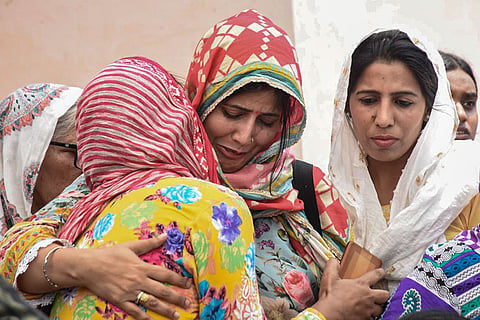 In this image received on May 2, 2026, Family members react after mortal remains of victims, who were found dead after a cruise boat carrying 29 passengers and two crew members overturned in Bargi Dam during a sudden storm in Jabalpur, were brought to Mayapuri, in New Delhi.