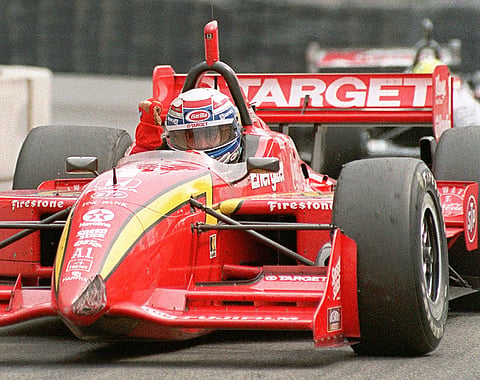 Alex Zanardi, of Italy, pumps his fist to the crowd as he rounds the track on his victory lap after winning the Toronto Molosn Indy
