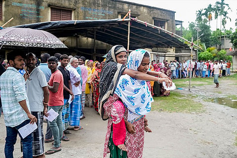 A specially-abled person being carried at a polling station during a repoll for the West Bengal Assembly elections, ordered by the Election Commission following reports of electoral malpractices, at Magrahat Paschim constituency, in South 24 Parganas district.