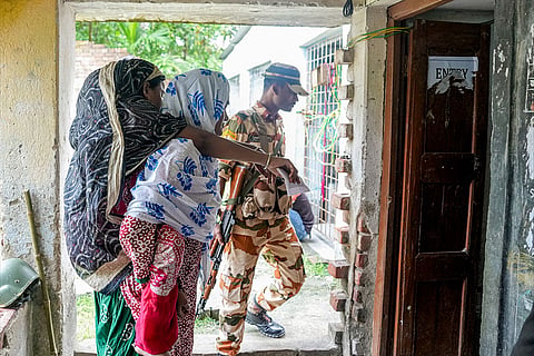 A specially-abled person being carried at a polling station as she arrives to cast her vote during a repoll for the West Bengal Assembly elections, ordered by the Election Commission following reports of electoral malpractices, at Magrahat Paschim constituency, in South 24 Parganas district.