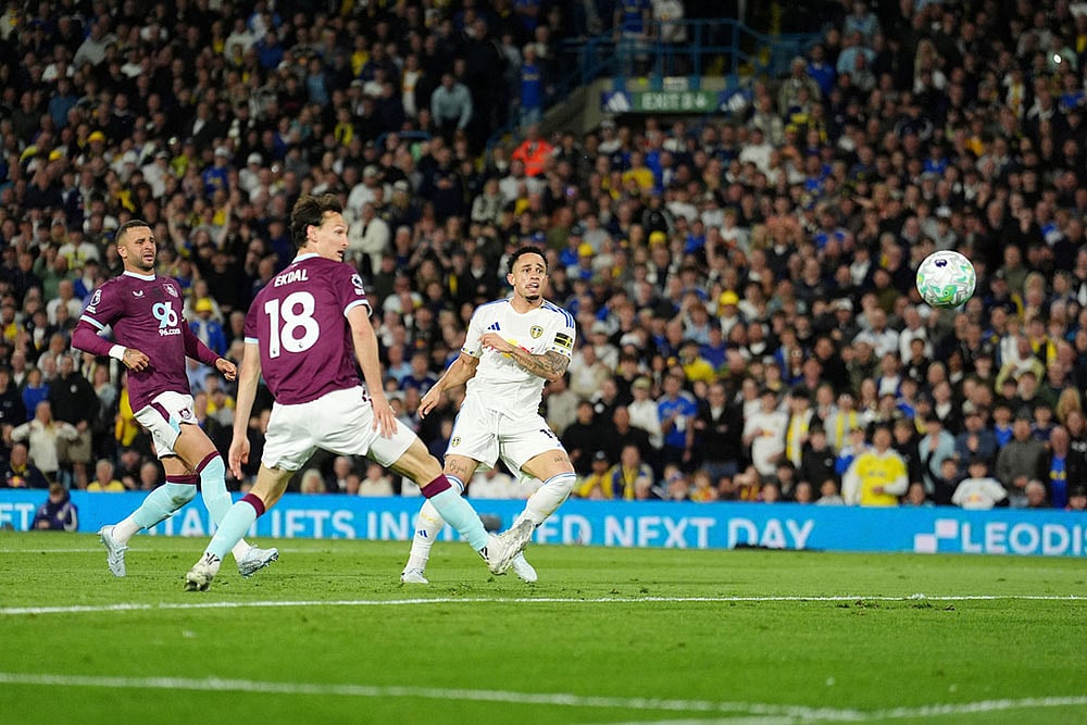 | Photo: Martin Rickett/PA via AP : Leeds United's Noah Okafor, right, scores their side's second goal during the Premier League match between Leeds United and Burnley, in Leeds, England.