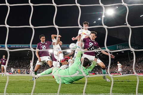 Leeds United's Dominic Calvert-Lewin, second from left, scores their third goal during the English Premier League soccer match between Leeds United and Burnley in Leeds, England.